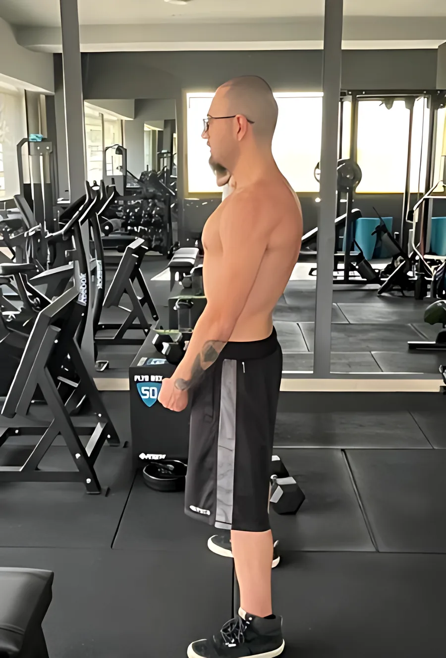 Side-profile progress check-in photo in the gym